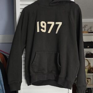 Essentials Black Pullover Hoodie with Cream "1977" Graphic